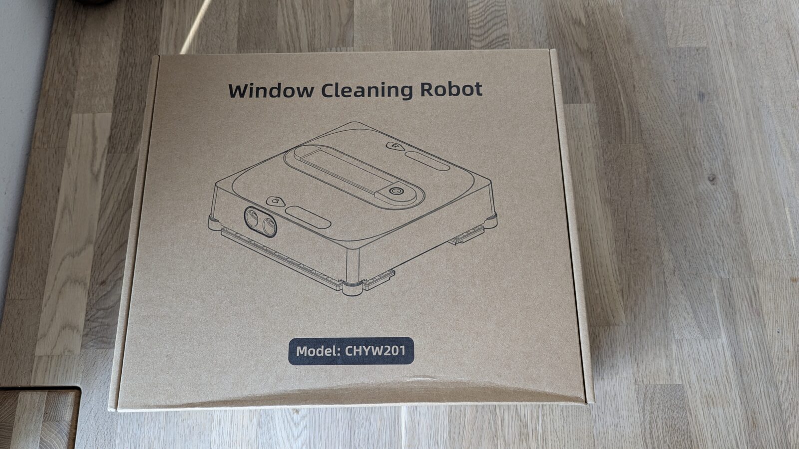Box of the lubluelu CHYW201 printed with "Window Cleaning Robot" and the CHYW201 model name, on our living room floor